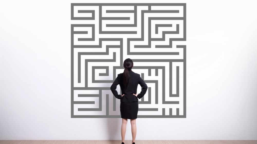 A person looking at a maze puzzle